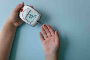 A diabetic man checking glucose level, illustrating the link between diabetes and depression.