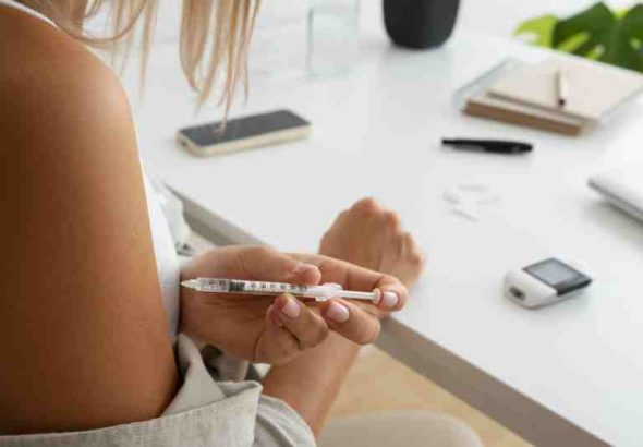 Woman checking blood sugar, showing diabetes self-care and family support.