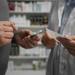 A patient consulting a healthcare professional, symbolizing public health services offering free medication to low-income individuals.
