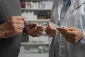 A patient consulting a healthcare professional, symbolizing public health services offering free medication to low-income individuals.