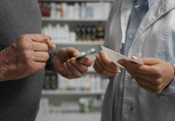 A patient consulting a healthcare professional, symbolizing public health services offering free medication to low-income individuals.