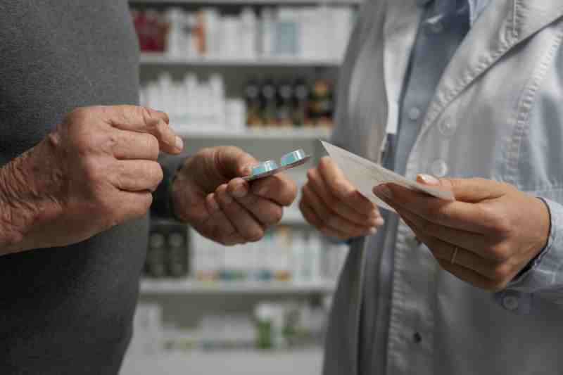 A patient consulting a healthcare professional, symbolizing public health services offering free medication to low-income individuals.