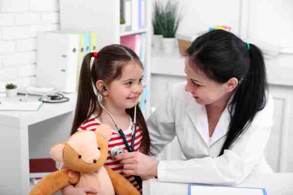 A doctor examining a child for signs of diabetes based on symptoms reported by the mother.
