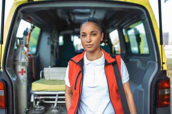 Ambulance staff are exiting the vehicle, responding to a diabetic emergency involving sudden unconsciousness due to hypoglycemia.