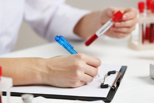 A lab technician checks the blood sample report to determine whether your blood sugar levels are normal, borderline, or clearly diabetic.