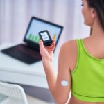 A woman with diabetes using a sensor to check glucose, highlighting the need to monitor blood sugar around exercise.