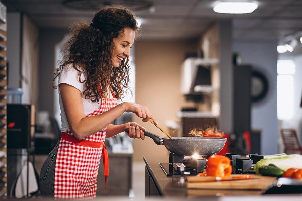 A person cooking at home, emphasizing portion control for managing diabetes.