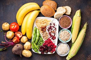 Healthy foods like fruits, vegetables, grains, and legumes representing the plate method for portion control in diabetes.