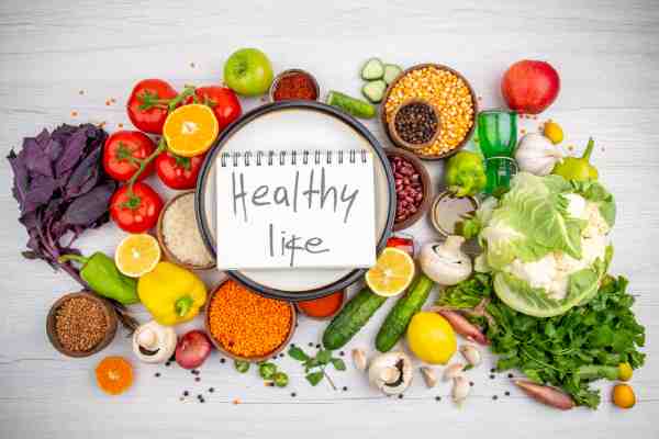 ‘Healthy life’ surrounded by fruits and vegetables, suggesting an environment that supports healthy habits.