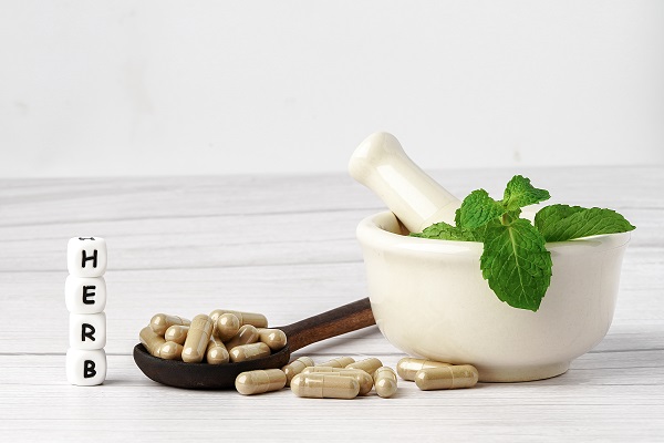 Herbal capsules with leaves representing Siddha medicine as part of an integrated treatment approach for diabetes.