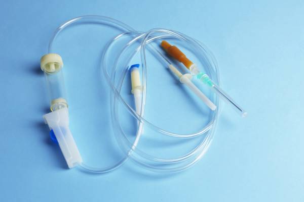 IV infusion set with needle, tubing, and connectors representing a diabetes technology device.