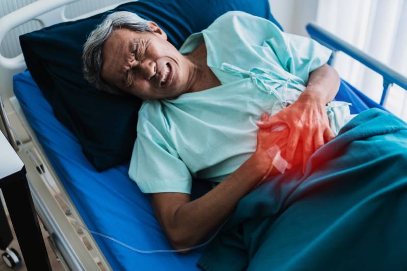Senior man holding his stomach in pain, highlighting how unawareness and unhealthy lifestyle choices can contribute to Type 2 diabetes.