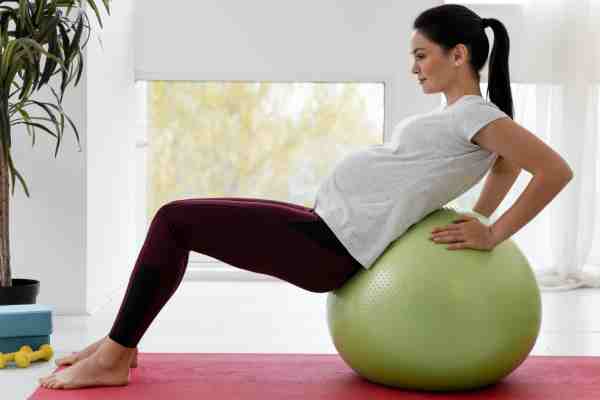 Pregnant woman practicing prenatal yoga to improve flexibility and breathing techniques.