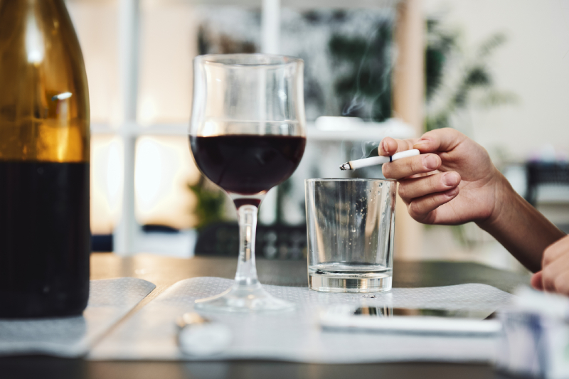 A person smoking and drinking, showing the health risks for those with diabetes.