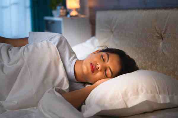 A young girl with diabetes sleeping in bed, symbolizing the importance of rest for proper body function
