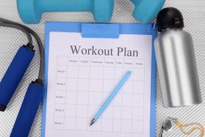 Sports equipment and a fitness schedule illustrating a basic weekly workout plan for diabetic patients.