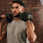 A person with diabetes lifting dumbbells, symbolizing how exercise helps control blood sugar levels.