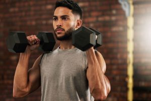 A person with diabetes lifting dumbbells, symbolizing how exercise helps control blood sugar levels.