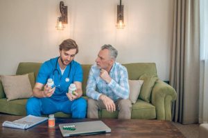 An elderly man consulting a doctor at home, stressing the need for medical guidance in type 2 diabetes.