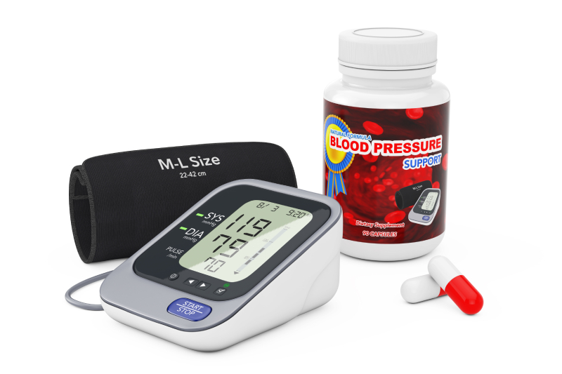 Digital blood pressure monitor and pills, highlighting the role of medication in managing hypertension.