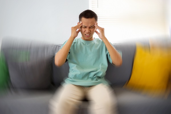 A man appearing dizzy and unwell, illustrating side effects linked to hypertension medication.