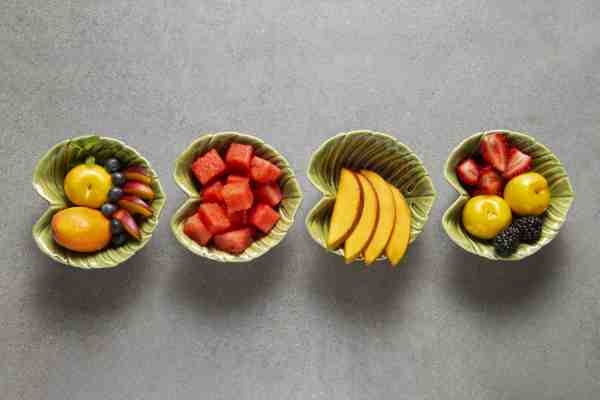 A bowl of fresh fruit, like watermelon, mango, plums, and berries, promotes a heart-healthy diet.