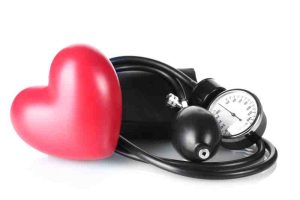Red heart and blood pressure monitor, symbolizing how high blood pressure increases heart attack risk.