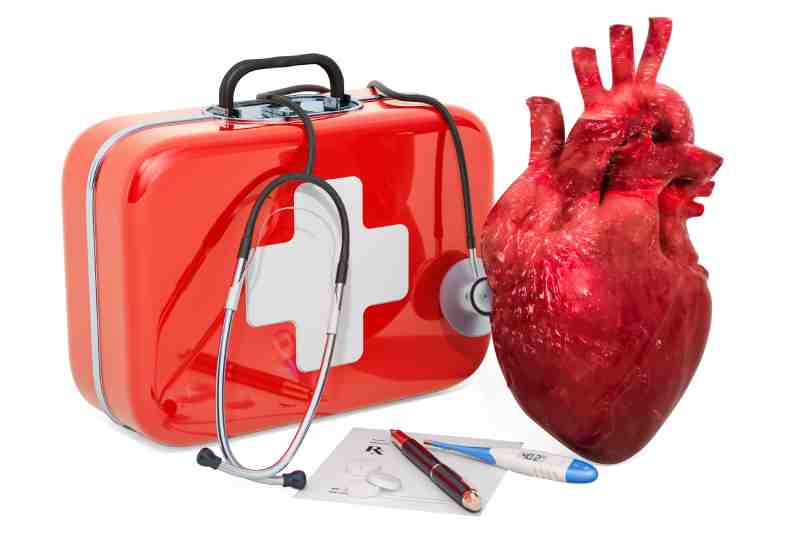 First-aid kit with stethoscope, heart model, thermometer, and prescription pad, symbolizing heart attack first aid.