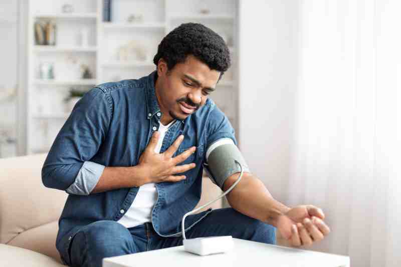 Man with chest pain and high blood pressure, suggesting a silent heart attack.