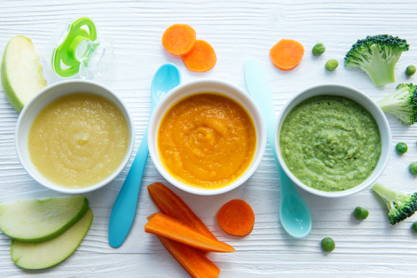 A bowl of pureed cucumber, carrot, and broccoli, representing healthy vegetable-based snacks.