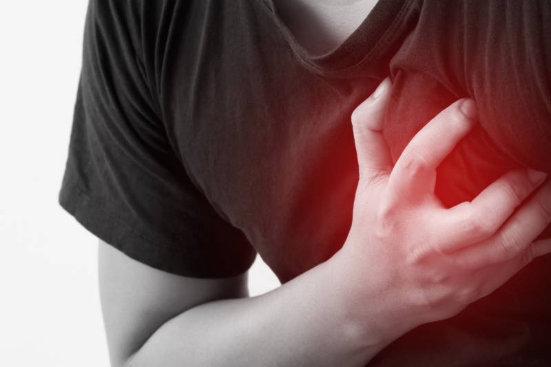 A person with chest pain, stressing the importance of recognizing heart attacks and the role of lifestyle and activity in prevention.