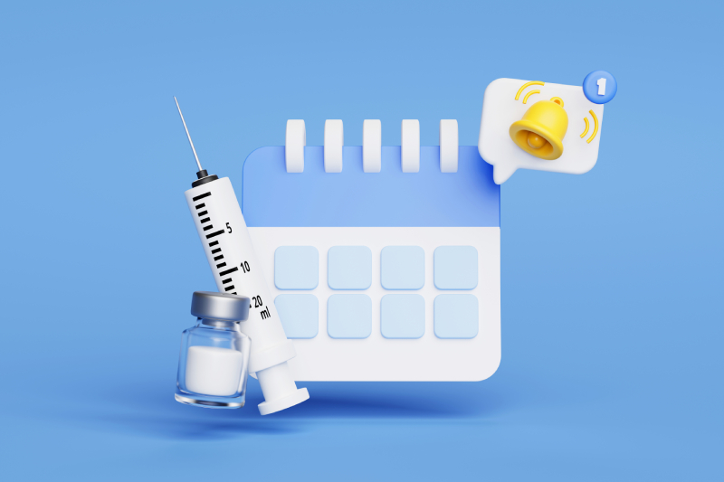 Calendar, syringe, vaccine vial, and reminder bell symbolizing the importance of timely vaccination.