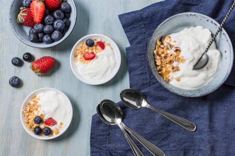 Greek yogurt with berries offers a tasty, satisfying snack that keeps blood sugar steady.