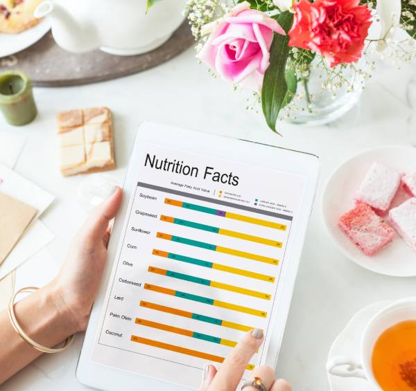 A tablet displays a "Nutrition Facts" table comparing nutrient levels in different oils, with color-coded bars.