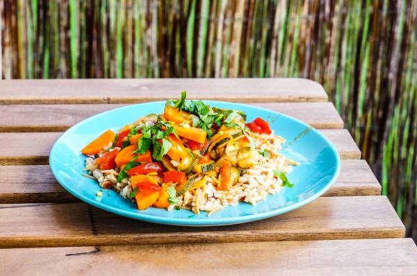 A plate with less rice and more vegetables, suitable for a diabetes-friendly diet.