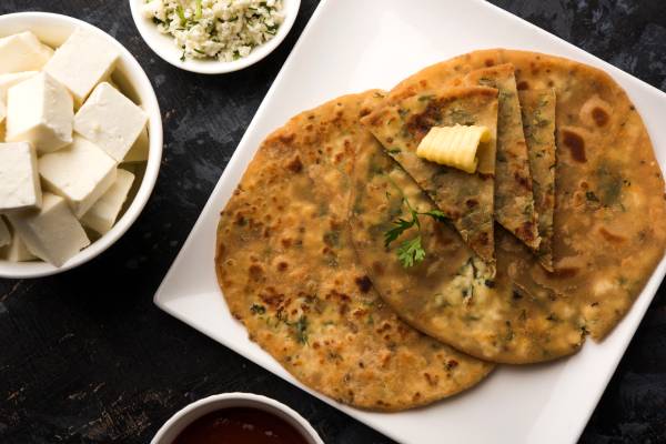 A filling snack of paneer and veggie stuffed roti, providing energy and long-lasting fullness.