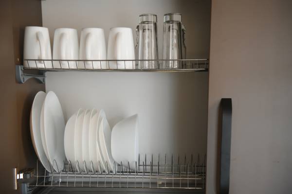 Plates, mugs, and glasses air-drying in a dish rack is scientifically the better method.