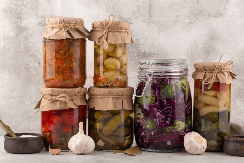 Jars of fermented foods, symbolizing the fermentation process in idli and dosa for easier digestion.