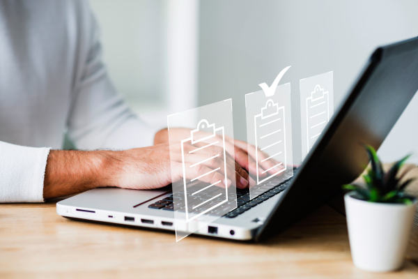 Person completing online document verification and inspection process for business license approval.