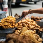 Street food vendor serving fried snacks, stressing that cleanliness of the stall reflects food quality.